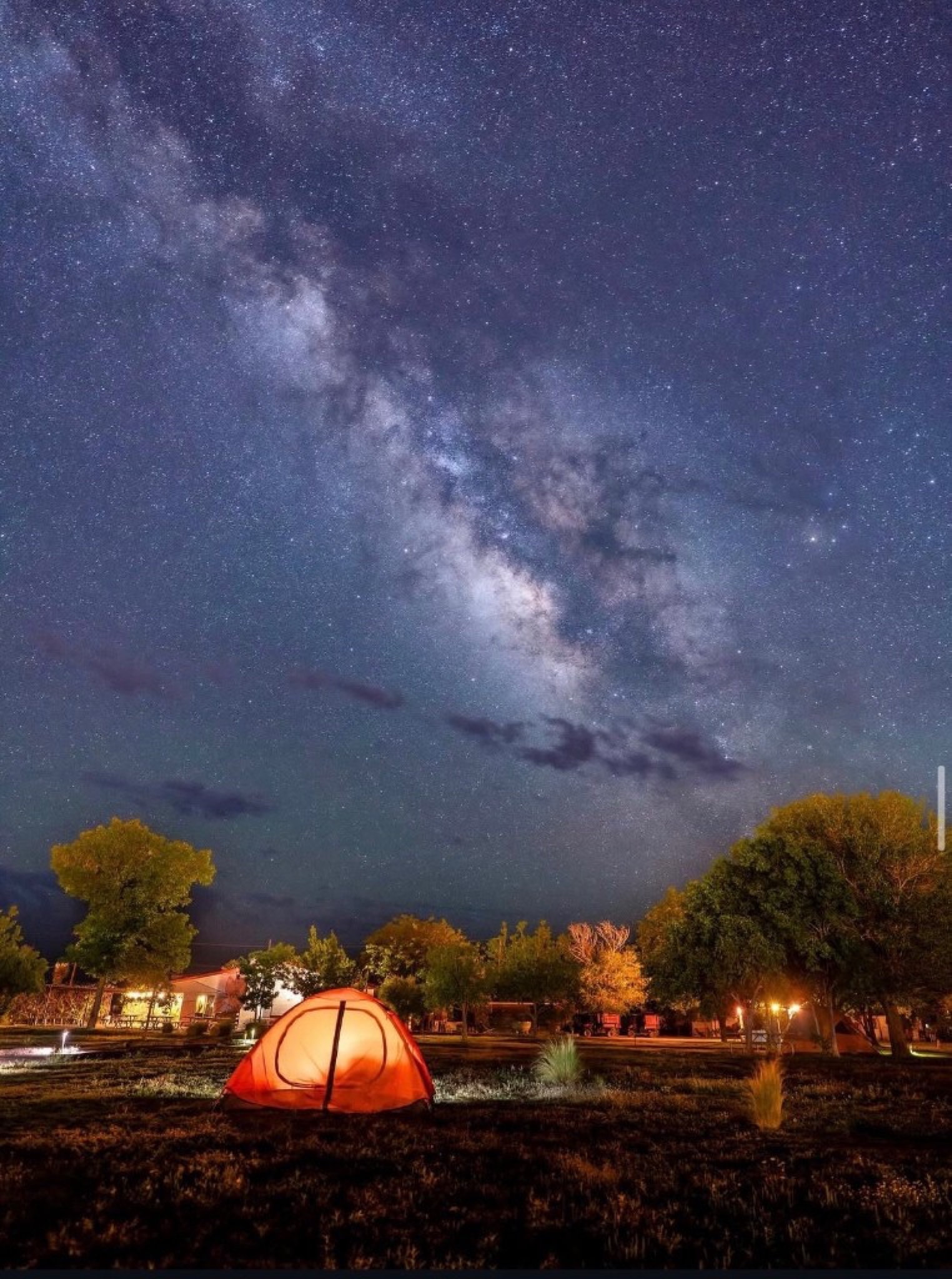 Glowing tent under the Milky Way at night